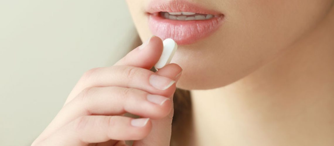 dental patient taking a sedative pill
