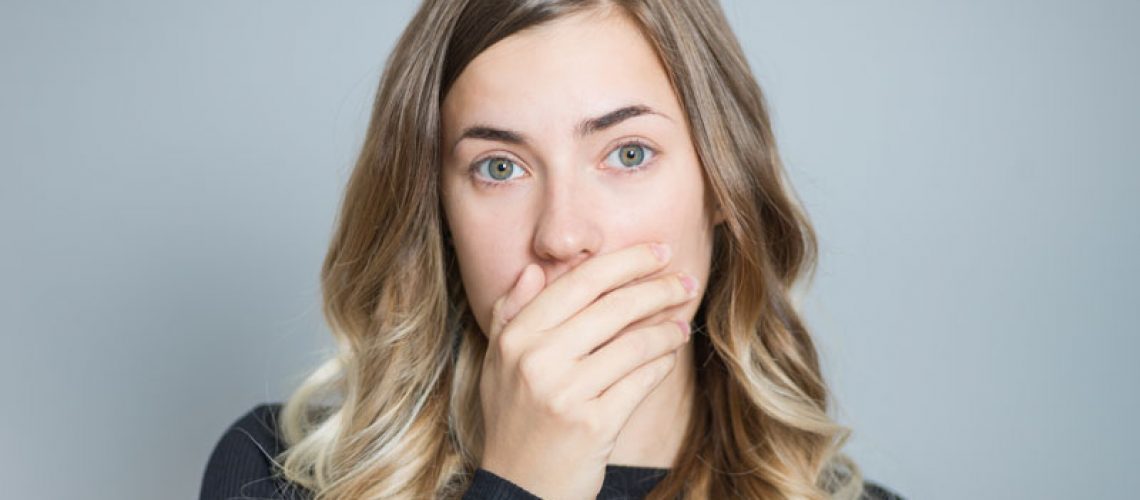 Dental Patient Shyly Hiding Her Missing Tooth