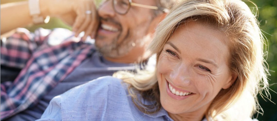 Two Full Arch Dental Implant Patients Smiling Together